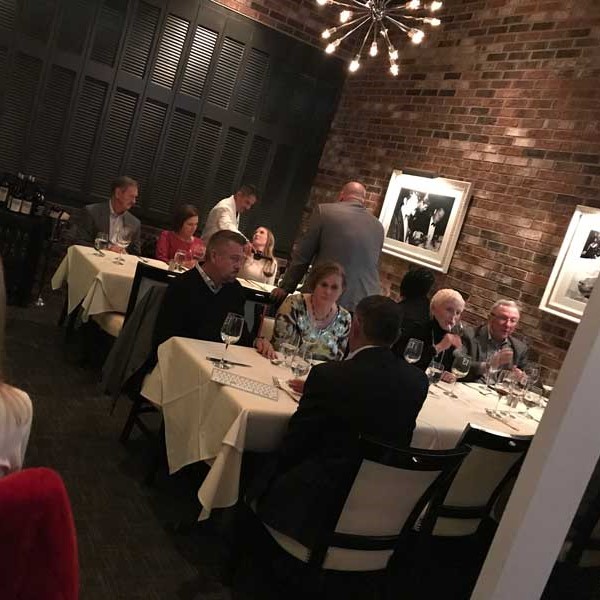 People eating at tables inside the Continental Room for private dining at Table 13